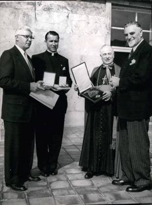 Sep. 26, 1953 - Bundesgovernment honours catholic priests from USA: Bundesminister Hans Lukaschek handels over by order of the Bundespresident the Bundesverdienst-crosses to three American Catholics, who did hart joined with a welfare-organisation for Germany. Photo shows (left) James J. Morris (european chief of the organisation to reduce war-cases), Alfred J. Schneider (director of this organisation), Arc-bishop Karl J. Alter, Cincinna ti, (Chairman of the curatorium of the organisation)  - ZUMAk09