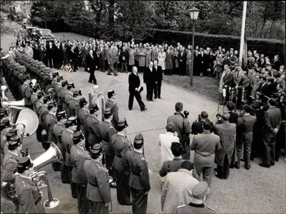 May 06, 1955 - Flag-parade at the Bundeskanzlerant: To the sounds of the Deustchlandliedes a flag parade took place in front of the Bundeskanzlerant. Ten years after the failure of the Nzi-regine the Federal Republic get its sovereignty finaly. Photo shows Dr. Adenauer, secretary of state Globke and referrent Kilb during hoisting the flag.  - ZUMAk09