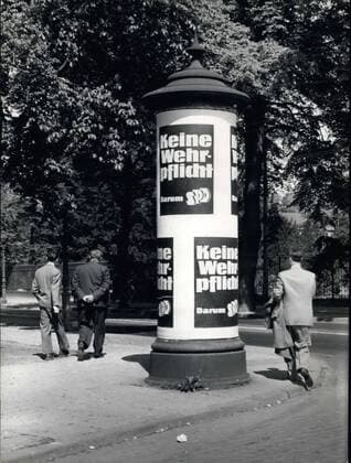 May 01, 1957 - The SPD has thought of a greeting of a different kind for the Foreign Minister of NATO, who is visiting Bonn. Exactly across the way from the Federal Chancellor s office and the Defense Ministry, the SPD has placed this placard in yellow and black. It makes it known that the SPD does not support conscription in Germany.  - ZUMAk09