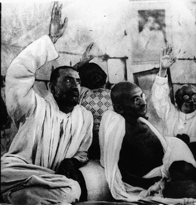 IMAGO ICONS: Mahatma Gandhi May 6, 1931 - Bombay, India - Religious leader MAHATMA GANDHI at The opening session of the Congress, the members decided that Gandhi should not retire. Gandhi quietly watches the demonstration of they re loyalty to him. Bombay India  - ZUMAk09