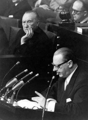 Dec. 1, 1955 - Bonn, Germany - West Germany s first chancellor KONRAD ADENAUER began his career in politics as a member of the Cologne City Council, becoming lord mayor of the city. Adenauer was elected Chancellor of the Federal Republic of Germany on 15 September 1949. PICTURED: Secretary of State HEINRICH VON BRENTANO giving a speech in parliament; KONRAD ADENAUER in the background. Bonn Germany  - ZUMAk09