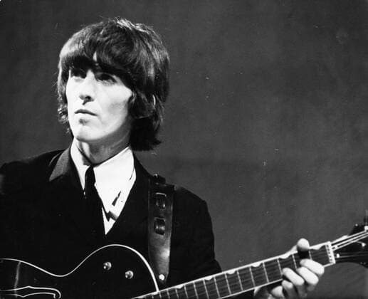Oct. 2, 1960 - London, England, U.K. - GEORGE HARRISON (1943–2001) was an award-winning English rock guitarist, singer, songwriter, author and sitarist best known as the lead guitarist of The Beatles. Harrison had a successful career as a solo artist and was also a film producer, with his production company Handmade Films. PICTURED: GEORGE HARRISON performs during concert. London UK  - ZUMAk09