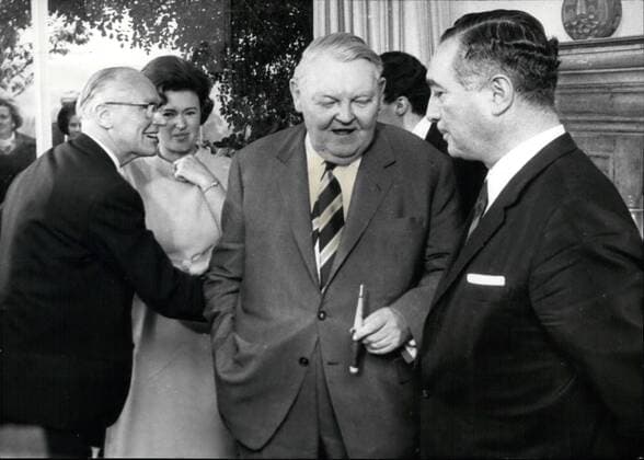 Oct. 10, 1966 - Dr. Erich Mende is 50. years old. One day after the Koalitionskrise (government-crisis) at Bonn (this was on Oct. 27th) Dr Erich Mende could celebrate his 50th birthday. Dr Mende, who was Vice-Chancellor and German Minister for East-West-German questions and resigned on October 27th from these two positions in connection with the Household-Problems of the Government, is the leader of the FDP (Freie Demokratische Partei). Together with Dr. Erich Mende also the three Further Ministers of the FDP-Bucher, Scheel and Dahlgrun-resigned during the congratulation-cour for Erich Mende on Oct. 28th, in Bonn also Chancellor Prof. Ludwig Erhard was present. Our picture shows: Ex-Minister Westrick, Mrs. Margot Mende, Mende-son Marcus (in the background), Chancellor erhard and Erich Mende.  - ZUMAk09