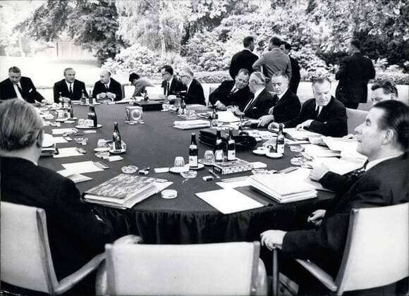 Jul. 07, 1967 - The chancellor and his ministers decided to have some fresh air. Surely this will help them make decisions quickly and correctly. They are discussing the finance planning together. Picture was taken on July 6, 1967 in Schaumburg Palace s park.  - ZUMAk09