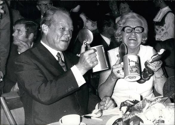 Sep. 09, 1970 - Federal Chancellor Willy Brandt in Munich: For the purpose of an election meeting Federal Chancellor Willy Brandt came to visit the Bavarian capital. The second part of it not quite as official as the first took place by a typical Bavarian atmosphere. With a brass-band playing, bretzels and beer in mugs a little Oktoberfest was being celebrated eight days before the real will be opened. Willy Brandt appeared at a beer-tent at the world-famous grounds of the Oktoberfest in Munich, W. Germany, it has been one of the most cheerful conference of the SPD-Party for some time. Photo shows Chancellor Brandt together with the German Minister of Health, Mrs. Kaethe Strobel drinking at their health.  - ZUMAk09