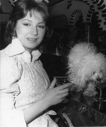 May 9, 1977 - London, England, U.K. - Singer MARIE MYRIAM celebrates her win at the Eurovision Song Contest with a glass of champagne and her puppy. London United Kingdom  - ZUMAk09