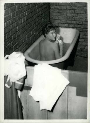 Sep. 15, 1953 - BEAUTY - IN THE BATH... GLYNIS JOHNS IN PRISON CELL. Glynis Johns and Diana Dors. are the stars of the new British film The Weak and the Wicked , which is being adapted from Joan Henry s best selling account after she spent eight months in prison.. During the film the stars take a bath - in a prison cell.. Keystone Photo Shows:- Glynis Johns beathes before the camera - in a prison cell - during production of the new British film.  - ZUMAk09