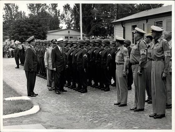 Jul. 23, 1956 - American Army-minister visit German soldiers in Andernach. Photo Shows Army minister Brucker (civil), Maj. General Laegeler (left) and Brig. General Uffner (MAAG) reviewing the German and American honor Guard.  - ZUMAk09