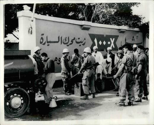 Nov. 11, 1956 - Latest Scenes from the Suez Area... Egyptians Queue for Fuel oil: While motorists in this country are experiencing difficulties in obtaining petrol- owing to the forthcoming petrol rationing - thanks to the Suez situation - the Egyptians are themselves feeling the pinch. They can be seen lining up every day - for kerosene - for cooking purposes. Photo Shows British and French troops supervising a queue of Egyptian at El Raswa on the outskirts of Port Said. The queue is for Kerosene fuel; oil.  - ZUMAk09