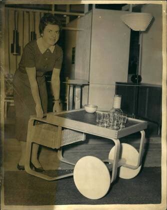 Designklassiker von Alvar Aalto Jan. 01, 1958 - Furniture Exhibition at Earl s Court: Photo shows Miss Inga Glin Gehberg, of Copenhagen, demonstrating this Finnish ten trolley, designed by Prof. Alvar Aalto, which is made of biron which a top of ceramic tiles, at Earl s Court today, where the Furniture Exhibition opens on Wednesday.  - ZUMAk09