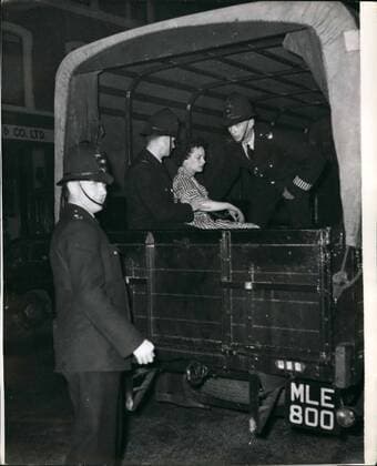 Sep. 09, 1958 - Black - White racial riots once again in Notting Hill Gate. Woman in a Police van: Many arrests were made last night in the Black White racial riots which broke out again for the fourth night in succession in the Notting Hill Gate area of London. Photo shows a woman in a police wagon after the riots in Blenheim Crescent, Notting Hill Gate last night.  - ZUMAk09