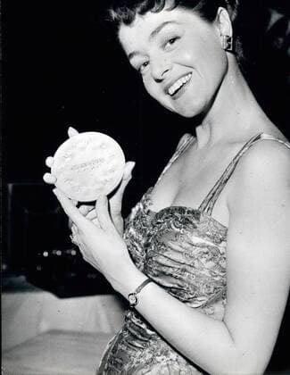 Mar. 03, 1959 - A Dutch Girl awarded the price of the best European Song: The best song of the year is a Dutch Song entitled A Little ....so has decided an International Jury. The Prize was handed to the young singer Teddy Scholten at the Palais Du Festival in Cannes yesterday. Photo Shows Teddy Scholten with her medal.  - ZUMAk09
