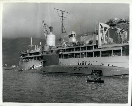 Mar. 03, 1961 - DEMONSTRATIONS AS POLARIS SUBMARINES ARRIVES ...LOCH... The 6700 tom American Polaris submarine PATRICK HENRY arrived in the Holy Loch-Firth of Clyde today-and tied up alongside the Submarine Depot Ship Proteus ...On arrival she was checred by the Royal Navy and demonstrators the vessels...One lone demonstrator in a small cance-dodgod police launches for some time but eventually he capsized and had to be fished out of the water by naval frogmen. KEYSTONE PHOTO SHOWS: A Demonstrator in a small boat alongside the submarine PATRICK HENRY-and the depot ship Proteus -in the Holy Loch-Firth of Clyde today.  - ZUMAk09