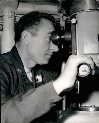 Feb. 02, 1963 - British Pressmen Visit the U.S.S. Polaris Submarine Ethan Allen A number of British pressmen today paid a visit to the United States Polaris submarine moored near Holy Look - Scotland - and were taken on a trip to sea. Ten officers and 90 men operate the 0,000,000 vessel - which is said to carry more destructive power than that unleashed by both sides during the whole of the last war. Photo Shows: Captain P.L. Laci, Commanding Officer of the U.S.S. Ethan Allen, the Polaris submarine, as seen looking through the periscope on board today.  - ZUMAk09