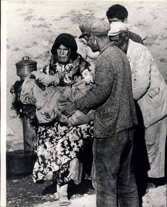 Aug. 25, 1966 - Earthquake scenes from Turkey. Original pictures just received, show scenes from Varto, which took the full force of the earthquake which struck provinces in Eastern Turkey last Friday, and which killed 2,300 people and rendered 70,000 homeless.Photo shows the grief - stricken mother receives the body of her child and bearing it in her arms she walks slowly through the village . She has a few minutes at her disposal to wash her dead child and wrap it in some blankets before it is to be buried.  - ZUMAk09