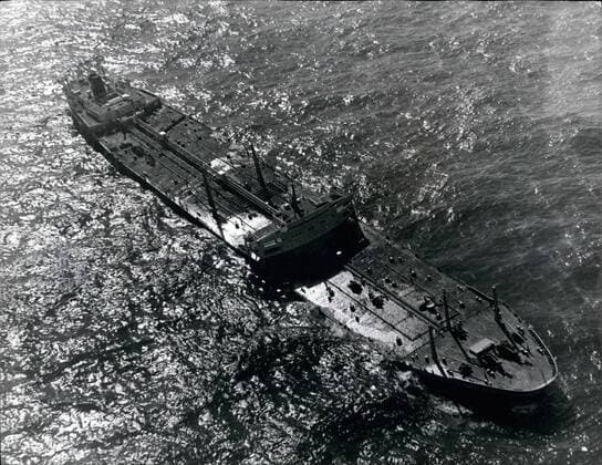 Mar. 03, 1967 - Oil from Crippled Tanker threatens beaches.: Efforts are being made to save the beaches of Cornwall and the Scilly Isles from the threat of oil from the crippled giant 61,000-ton tanker Torrey Canyon, which lies on the Seven Stones Reef between the Scilly Isles and Land s End. Photo shows: Aerial view of the crippled tanker Torrey Canyon, which lies helpless on the Seven stones reef off Land s End.  - ZUMAk09