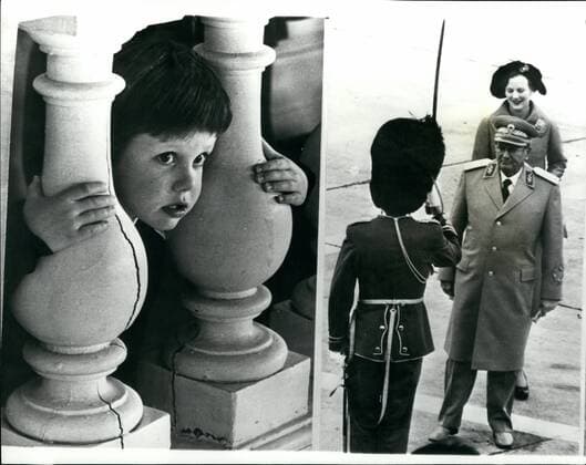 Oct. 10, 1974 - President Tito s state visit to Denmark - the Danish crown Prince is a secret onlooker.: President Tito of Yugoslavia, accompanied by his wife, is currently on a four day state visit to Denmark. Photo shows a join up picture showing the young Danish crown- Prince Frederick gets a view of the proceedings from the balcony of Frdensborg castle - and on right President Tito followed by Queen Margareth of Denmark gets the salute from an officer of the Royal guard.  - ZUMAk09