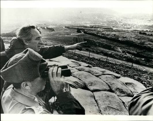 Jan. 01, 1976 - Israeli Defense Minister Tours Lebanese Border Defenses - The Israeli defense minister, Mr Shimon Peres made a tour of the Lebanese Border Defenses in case Syian armed forces should invade Lebanon, Israel will take such measures as indicated by the situation created along the Northern Border with the Lebanon Mr Peres added that possible entry of the Sybian Army into Lebanon, and the presence there of large numbers of Palaentinian terrrists. These two problems are being followed closely as having direct implications an Israel s security. What his happening in Lebanen among the warring factions was an internal affair, on which Israel has no wish to comment-said Mr Peres during his tour. Photo Shows: Defence Minister Mr Shimen Peres seen looking across the Northen Border of the Lebanon as a officer points out landmarks.  - ZUMAk09