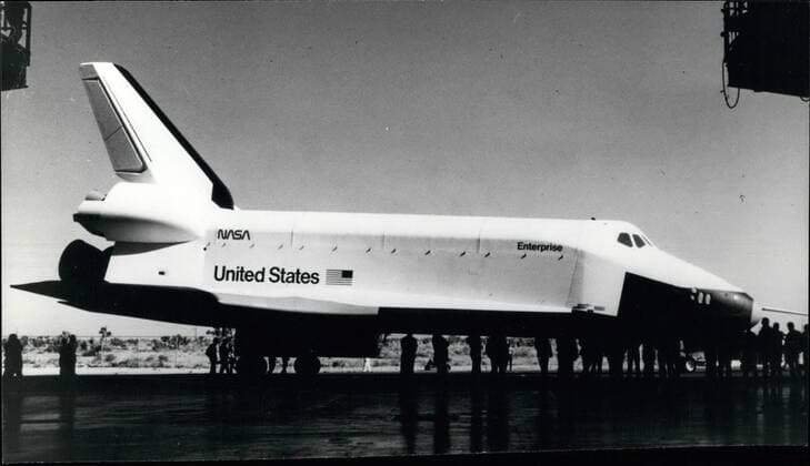 Dec. 12, 1976 - Shuttle Orbiter 101 Rollout. Photo Shows: A ground level view of the Space shuttle orbiter 101 Enterprise during rollout activity at the Rockwell International Space Division s Orbiter manufacturing facility at Palmdale in California. The Enterprise will be moved to the NASA Dryden Elight Research centre 35 miles north of Palmdale, where it will undergo tests flights in the atmosphere in 1977. Those flights will be the prelude to Shuttle Orbiter flights into Earth orbit in 1979 by the second Orbiter (102), now under construction.  - ZUMAk09