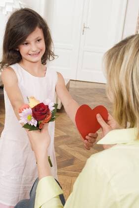 Girl (8-9) giving her mother a gift model released property released  NH00642