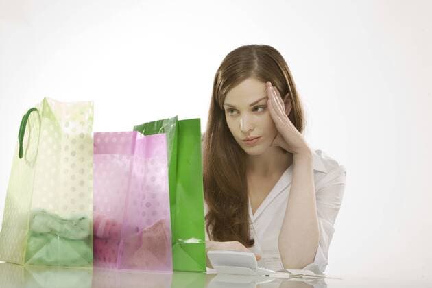 Young womanwith shopping bags, thinking, portrait model released  CLF00391