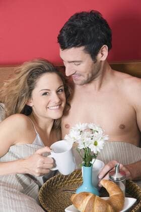 Young couple having breakfast in Bed model released property released NHF00985