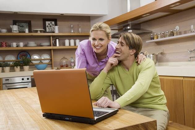 Young couple in kitchen, using laptop, portrait model released property released  WESTF08027
