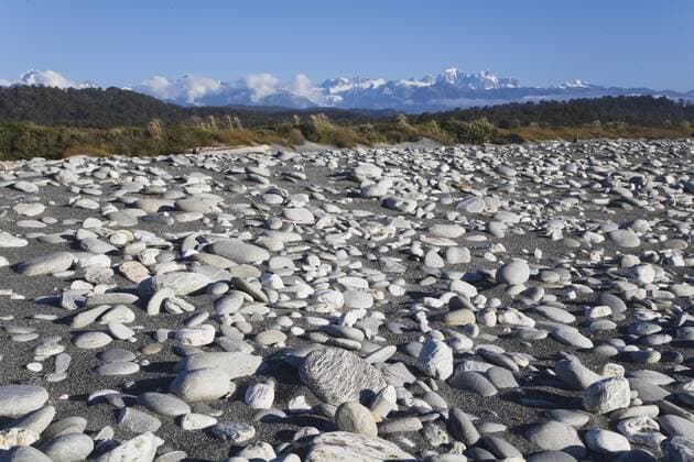 New Zealand, South Island, West Coast, View of west coast beach with mountains in background  GWF001324