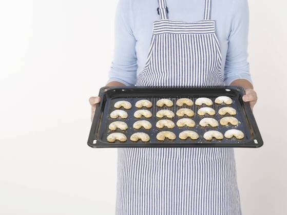Senior woman holding tray of cookies model released  KNF000698
