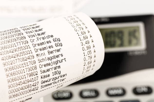 Shopping receipt for groceries with calculator, close up  EJWF000176