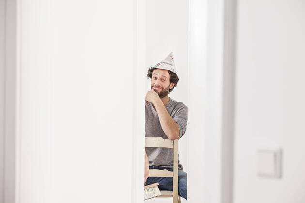 Portrait of man sitting on chair, smiling model released property released  FMKF000639