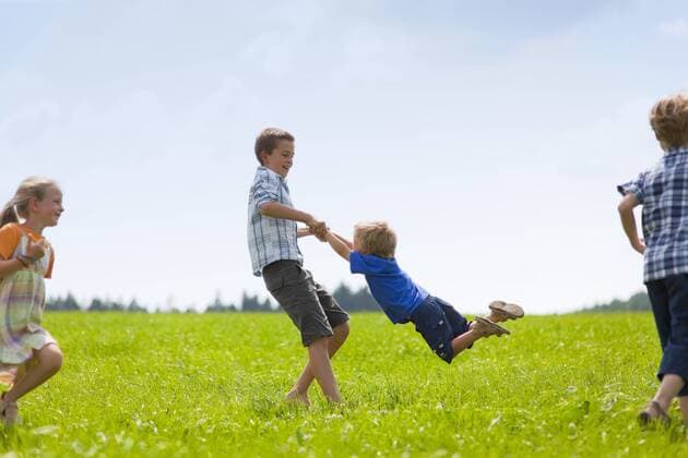 Germany, Bavaria, Group of children playing in meadow model released property released  HSIYF000029