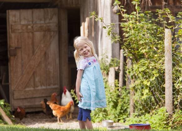 Germany, Bavaria, Girl with chicken on farm model released property released  HSIYF000104