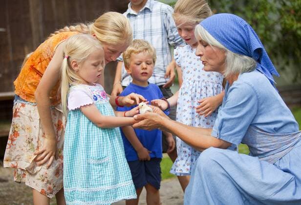 Germany, Bavaria, Farm woman with children holding baby chick model released property released  HSIYF000161