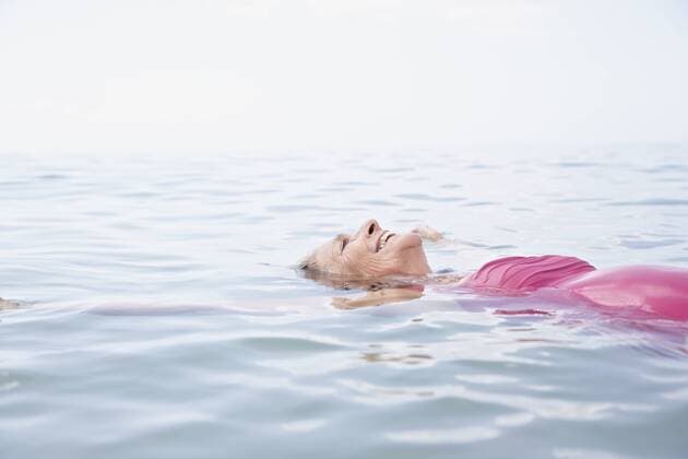 Spain, Senior woman swimming in Atlantic model released  PDYF000244