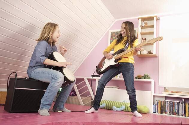 Girls playing guitar and drums, laughing model released  RNF001054