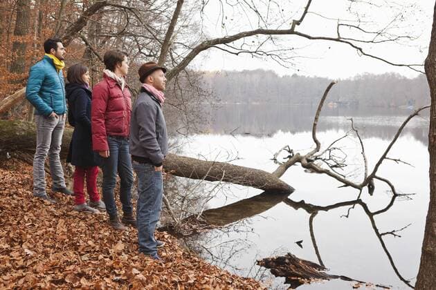 Germany, Berlin, Wandlitz, Men and women standing by lake and looking at view model released  WESTF018240