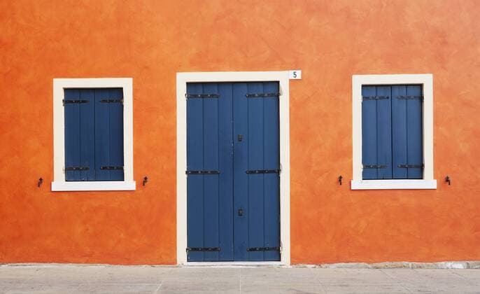 Italy, Province of Venice, Caorle, Facade of building with blue door  WWF002362