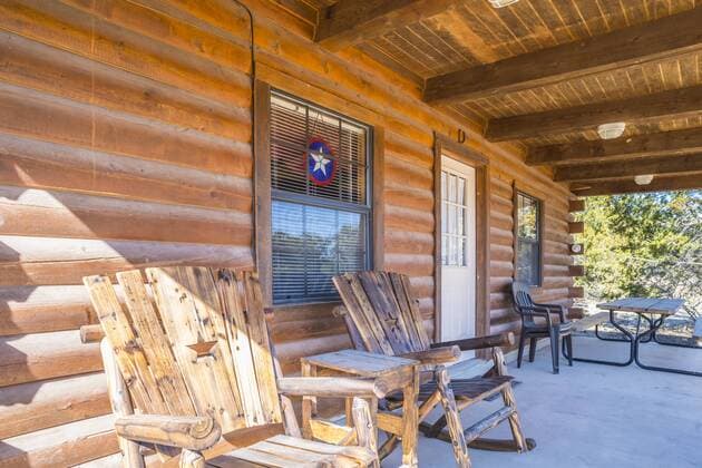 USA, Texas, Veranda of a log house with wooden chairs property released  ABAF001184