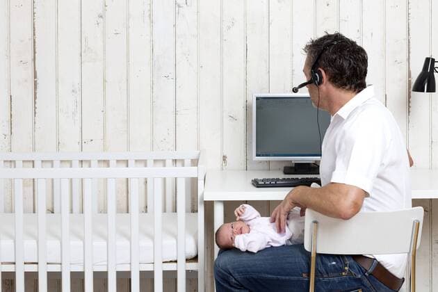 Man at home office with his baby model released property released  DRF000939