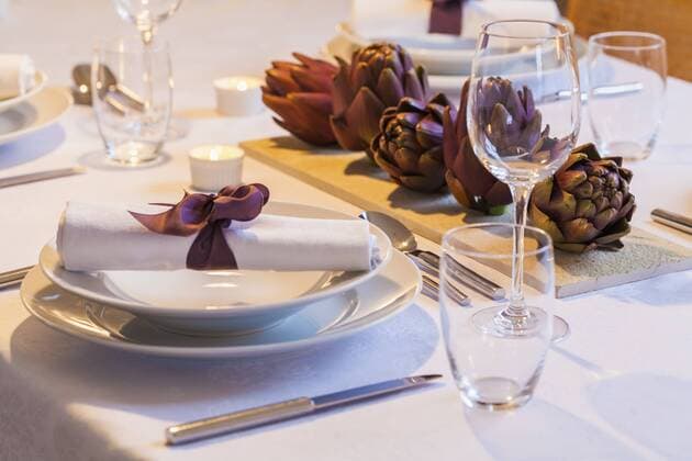 Place setting and decoration with artichokes on festive laid table property released  WDF002315