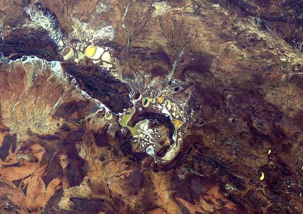Shoemaker Crater, Australia, True Colour Satellite Image. True colour satellite image of Western Australia s Shoemaker impact structure. Resembling splotches of yellow and green paint, salt-encrusted seasonal lakes dot the floor of the impact struct 913_03_PO00290
