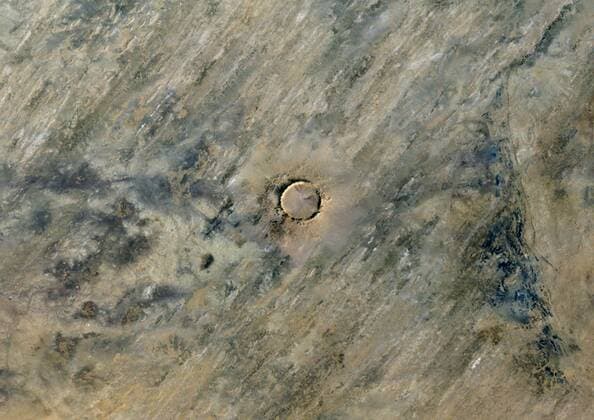 Tenoumer Crater, Mauritania, True Colour Satellite Image. True colour satellite image of Tenoumer meteor crater in Mauritania. It is 1.9 km in diameter and the age is estimated to be 2.5 million years old. Image taken on 21 March 1988 using LANDSAT 913_03_PO00291