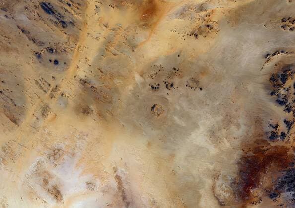 Meteor Impact Crater, Libya, True Colour Satellite Image. True colour satellite image of an impact structure North of Koufra Oasis (24°06 N - 23°24 E), in the Libyan desert. Image taken on 9 November 1986 using LANDSAT data. 913_03_PO00450