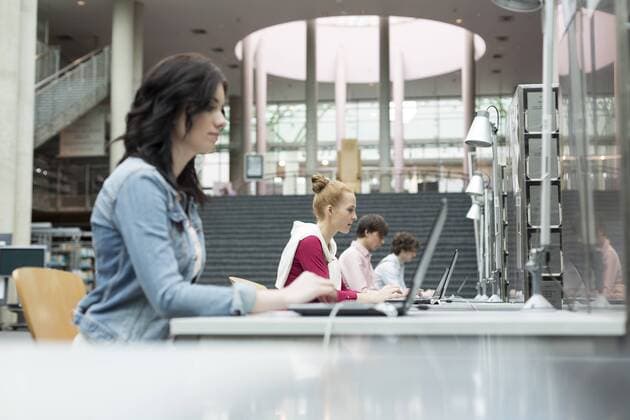Students using laptops in a university library model released Symbolfoto property released  WESTF019690