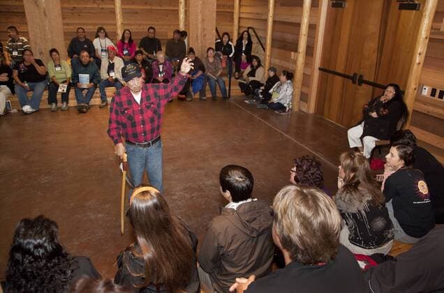 Tulalip Tribal member, storyteller and elder Ray Moses welcomes a group of visitors with colorful stories about Coast Salish culture during an afternoon event inside the Tulalip Tribes longhouse located at the Hibulb Cultural Center. Marysville, WA 969_08_NWCS-21