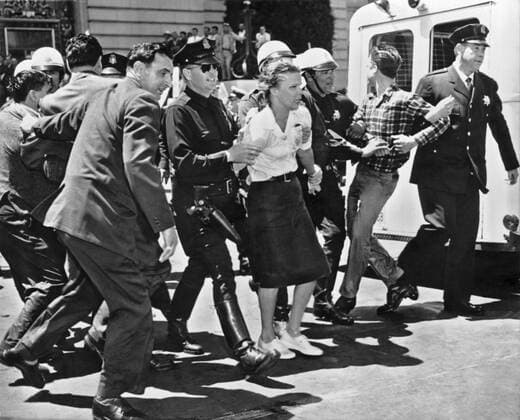 San Francisco, California: March 1, 1961. Three wet and defiant protesters of the House Un-American Activities Committee hearing at San Francisco City Hall are taken to the paddy wagon Sixty four total college age persons were arrested after being hosed by the police. The HUAC claimed that Communists masterminded the protest. 990_16_7-Hist-Dem_2HR