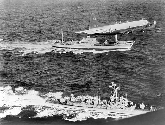 Cuba: 1962 The Soviet freighter Anosov, rear, being escorted by a Navy plane and the destroyer USS Barry, while it leaves Cuba probably loaded with missiles under the canvas cover seen on deck 990_16_X-Kennedy-JF-CMC_2HR