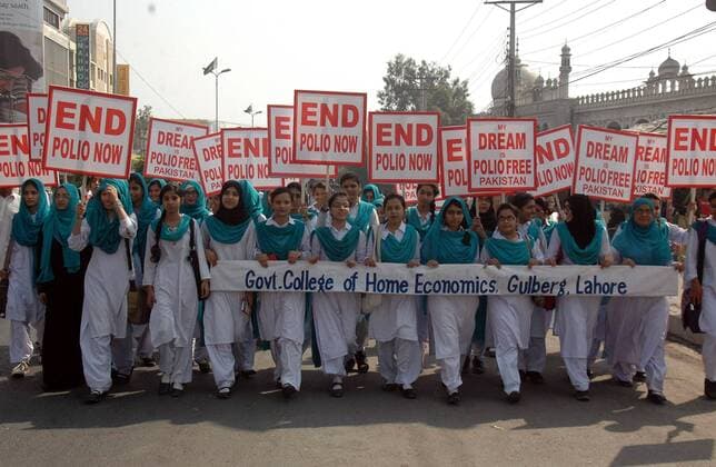 Pakistani students hold placards during a rally to mark World Polio Day in eastern Pakistan s Lahore on Oct. 24, 2014. World Health Organization said Friday that three more polio cases have surfaced in Pakistan, bringing the number of new cases to 220, a record figure that authorities blame on attacks by insurgents targeting vaccination teams. )(zhf) PAKISTAN-LAHORE-POLIO DAY-RALLY Sajjad 