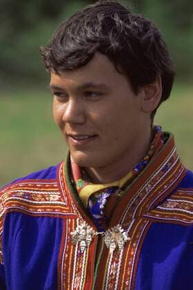 Young male Sami dressed in traditional Kofte dress, Alta river, Samiland Lapland, Finnmark, Northern Norway. 1997.  1114965 PetexOxford